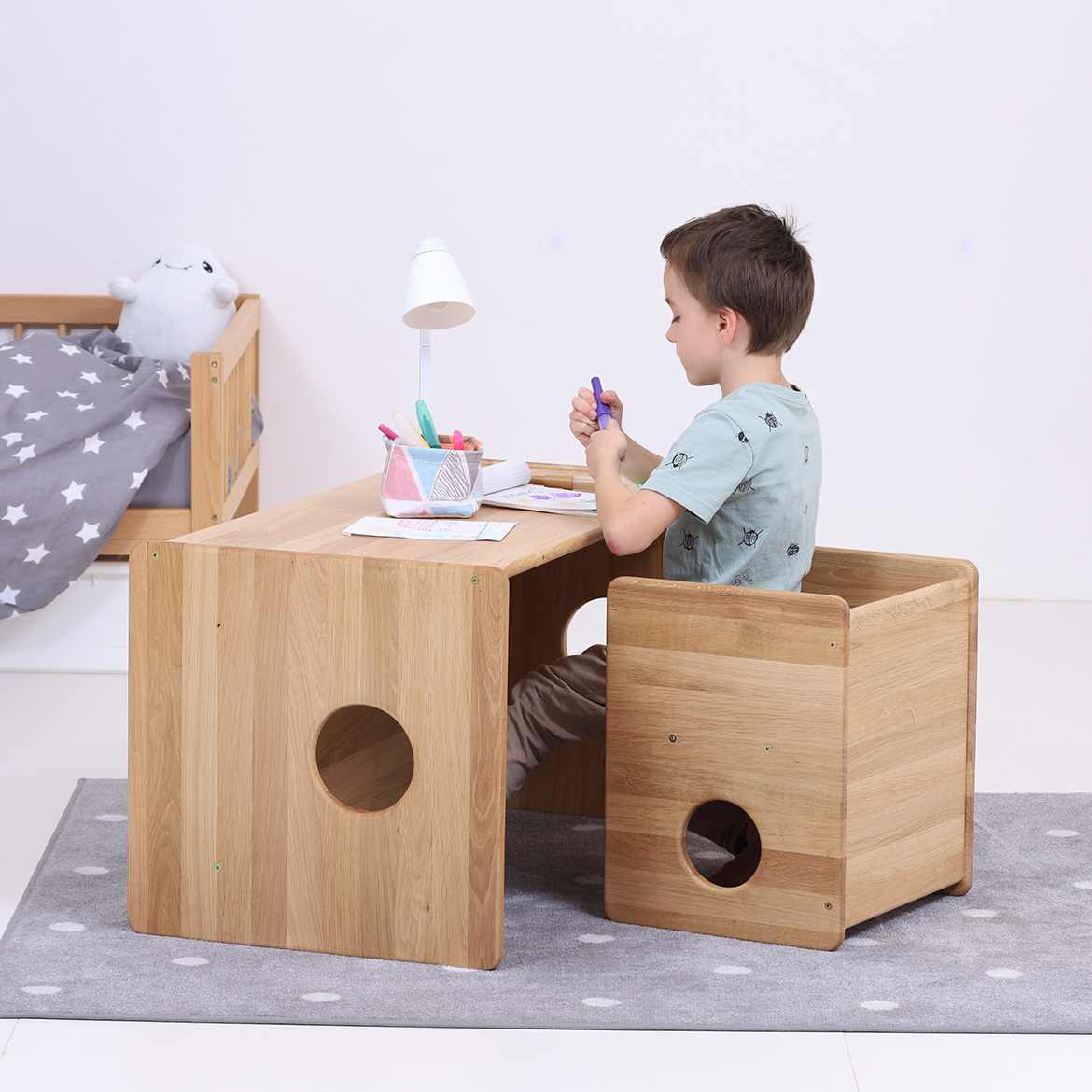 Lubo Majer for Brubi – child sitting at Cube Chair and Table set in oak wood, children's reversible wooden desk and chair in kidsroom