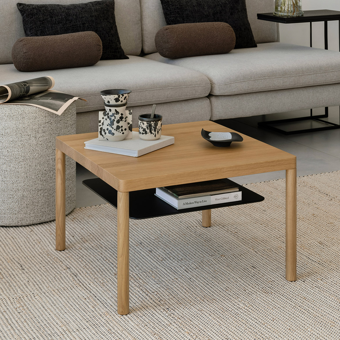 Lubo Majer for Take me HOME – Aldo square oak coffee table with black metal shelf in living room setting